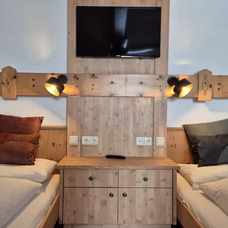 Cozy bedroom with two beds and TV.