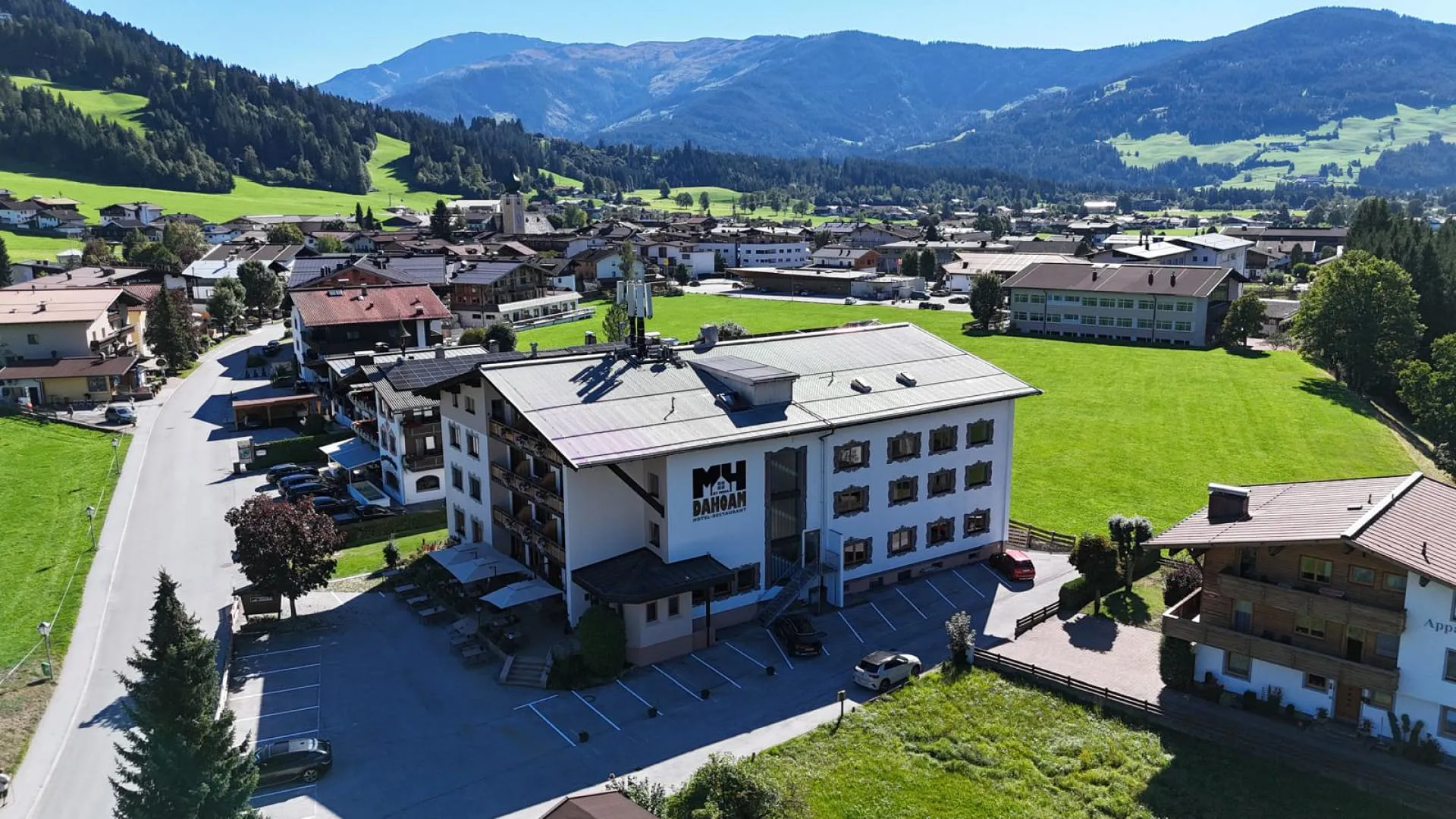 Aerial view of a town with buildings and mountains.