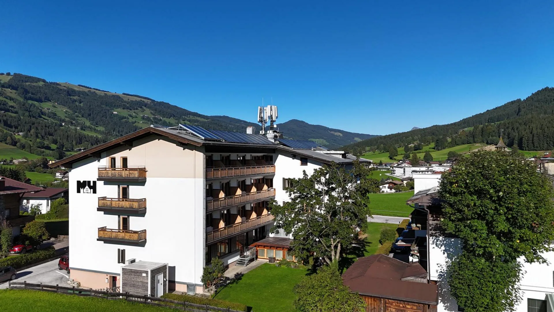 Hotel building with solar panels in the mountains